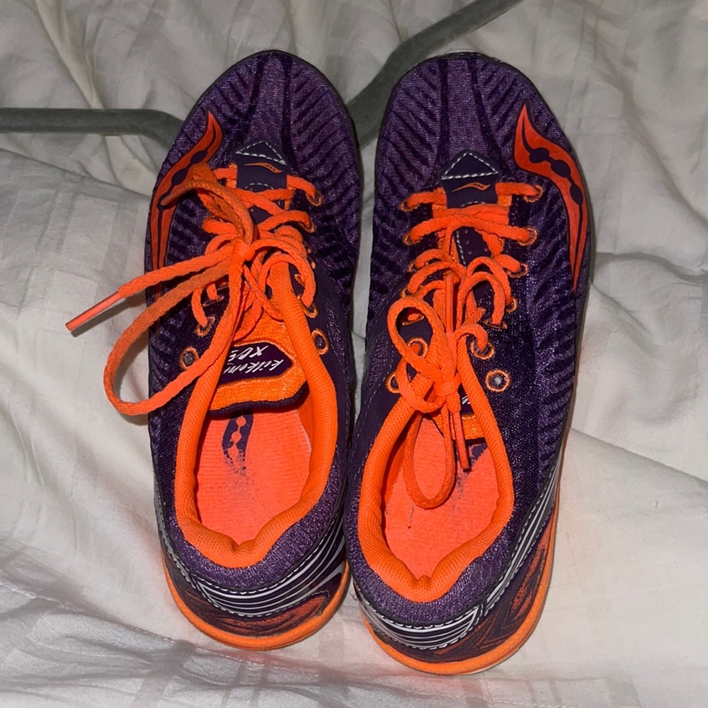 Saucony purple and orange spike running shoes